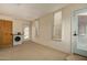 Laundry room with washer, wood door, access to backyard, and window with blinds at 1448 E Royal Palm Rd, Phoenix, AZ 85020