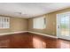 Spacious living room with hardwood floors, neutral paint and natural light from the windows at 1448 E Royal Palm Rd, Phoenix, AZ 85020