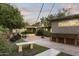 Expansive backyard with stone benches, lush landscaping, and cozy sitting areas at 1522 W Myrtle Ave, Phoenix, AZ 85021