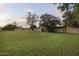 Expansive backyard with lush green grass, mature trees, and a view of a serene sunset at 1522 W Myrtle Ave, Phoenix, AZ 85021