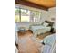 Sunlit bedroom featuring twin beds, wood floors, and large window with a view at 1522 W Myrtle Ave, Phoenix, AZ 85021