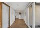 Hallway featuring clean lines, wood flooring, neutral tones, and ample storage space at 1522 W Myrtle Ave, Phoenix, AZ 85021
