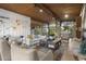 Bright living room with wood ceiling, large windows, stylish furnishings, and access to outdoor areas at 1522 W Myrtle Ave, Phoenix, AZ 85021