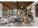 Spacious living room featuring a wood ceiling, a fireplace, and seamless indoor-outdoor flow at 1522 W Myrtle Ave, Phoenix, AZ 85021