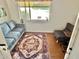 Comfortable living room featuring a soft couch, accent chairs, and large window at 1522 W Myrtle Ave, Phoenix, AZ 85021