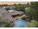 Serene outdoor space with a circular pool, cozy patio, and mature landscaping for ultimate relaxation at 1522 W Myrtle Ave, Phoenix, AZ 85021