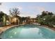 Swimming pool surrounded by a fence and mature landscaping provides a private oasis at 1522 W Myrtle Ave, Phoenix, AZ 85021