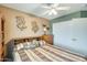 Cozy bedroom features decorative wall art, built-in headboard storage, and neutral walls at 15962 W Statler St, Surprise, AZ 85374