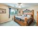 Bedroom featuring a decorative wood bed frame, ceiling fan, and a window view at 15962 W Statler St, Surprise, AZ 85374