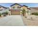 Attractive two-story home with a two-car garage, desert landscaping, and a wide driveway at 15962 W Statler St, Surprise, AZ 85374
