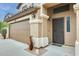 Inviting front entrance with a secure screen door, well-lit entryway and attached two-car garage at 15962 W Statler St, Surprise, AZ 85374