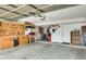Spacious garage equipped with tool storage, bikes, and an automatic door opener at 15962 W Statler St, Surprise, AZ 85374