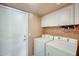 Laundry room featuring a white washer and dryer, cabinets and lots of storage at 15962 W Statler St, Surprise, AZ 85374