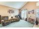 Cozy living room featuring vaulted ceilings, neutral walls, soft carpet and two comfortable armchairs at 15962 W Statler St, Surprise, AZ 85374