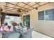 Inviting covered patio with comfortable seating, ceiling fan and sliding glass door to inside at 15962 W Statler St, Surprise, AZ 85374