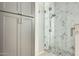 Tiled shower with glass door and built-in storage in a modern bathroom at 17514 N Rainbow Cir, Surprise, AZ 85374