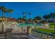 A vibrant community pool with ample seating, shaded areas, and lush landscaping at 17514 N Rainbow Cir, Surprise, AZ 85374