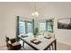Cozy dining area featuring a modern table setting, ample natural light, and view of the backyard at 17514 N Rainbow Cir, Surprise, AZ 85374