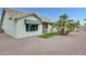 Charming single-story home with a tile roof, white stucco, and a well-maintained decorative yard at 17514 N Rainbow Cir, Surprise, AZ 85374