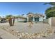 Attractive home featuring desert landscaping, a two-car garage, and a covered entryway with decorative features at 17514 N Rainbow Cir, Surprise, AZ 85374