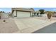 Well-maintained home with a two-car garage, desert landscaping, and a neatly manicured front yard at 17514 N Rainbow Cir, Surprise, AZ 85374