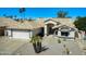 Charming single-story home featuring desert landscaping, a two-car garage, and a welcoming front entryway at 17514 N Rainbow Cir, Surprise, AZ 85374