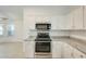 Kitchen with white cabinets, granite counters, and stainless steel oven and microwave at 17514 N Rainbow Cir, Surprise, AZ 85374