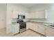 Updated kitchen boasts stainless steel appliances, granite countertops, and ample white cabinetry at 17514 N Rainbow Cir, Surprise, AZ 85374