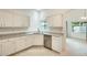 Bright kitchen showcasing granite counters, white cabinets, and stainless steel appliances at 17514 N Rainbow Cir, Surprise, AZ 85374