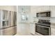 Bright kitchen featuring stainless steel appliances and open layout to the living area at 17514 N Rainbow Cir, Surprise, AZ 85374