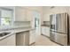 Bright kitchen with stainless steel dishwasher and refrigerator at 17514 N Rainbow Cir, Surprise, AZ 85374