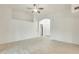 Bright, open living room boasts light tile floors, high ceilings, and a ceiling fan for added comfort at 17514 N Rainbow Cir, Surprise, AZ 85374