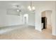Spacious living room featuring tile floors and access to kitchen, dining, and entry areas at 17514 N Rainbow Cir, Surprise, AZ 85374