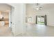 Bright and open living area featuring tiled floors, neutral colors, and sliding glass doors leading to the backyard at 17514 N Rainbow Cir, Surprise, AZ 85374