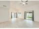 Spacious living area with tiled floors, high ceilings, and large windows offering plenty of natural light at 17514 N Rainbow Cir, Surprise, AZ 85374