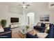 Bright living room featuring a comfortable sectional sofa, modern TV console, and stylish decor at 17514 N Rainbow Cir, Surprise, AZ 85374