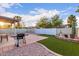 Backyard with patio area, pergola, grill, gravel and turf at 1758 E Birch St, Casa Grande, AZ 85122