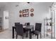 Dining area with white tile flooring, four chairs and shelving to the side at 1758 E Birch St, Casa Grande, AZ 85122