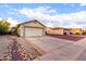 Single-story home showcasing a driveway and a two-car garage in a residential area at 1758 E Birch St, Casa Grande, AZ 85122