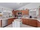 Functional kitchen with wood cabinets, tiled backsplash, and stainless steel appliances at 1758 E Birch St, Casa Grande, AZ 85122