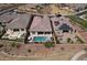 Aerial view showcasing a beautiful backyard pool, landscaping, and privacy fence at 18233 W Hope Dr, Goodyear, AZ 85338