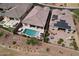 Aerial view of a backyard with a pool, spa, and covered patio at 18233 W Hope Dr, Goodyear, AZ 85338