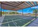 Covered basketball court for year-round play, nestled amid desert landscaping and tranquil lake views at 18233 W Hope Dr, Goodyear, AZ 85338