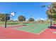 Full basketball court in a park-like setting with mature trees and landscaping at 18233 W Hope Dr, Goodyear, AZ 85338