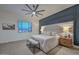 Serene bedroom with a padded headboard, ceiling fan, and ample natural light at 18233 W Hope Dr, Goodyear, AZ 85338