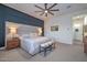 Inviting bedroom with a large headboard, modern lighting, and a comfortable bench at 18233 W Hope Dr, Goodyear, AZ 85338
