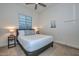 Comfortable bedroom featuring a king bed, neutral carpet, and a ceiling fan at 18233 W Hope Dr, Goodyear, AZ 85338