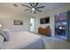 Stylish bedroom with ensuite access, ceiling fan, and convenient patio access at 18233 W Hope Dr, Goodyear, AZ 85338