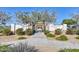 Inviting entrance to Bougainvillea Park with stone columns, decorative gate, and landscaping at 18233 W Hope Dr, Goodyear, AZ 85338