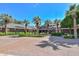 Well-maintained brick clubhouse exterior with manicured landscaping, palm trees, and a welcoming entrance at 18233 W Hope Dr, Goodyear, AZ 85338